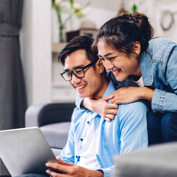 couple looking at checking accounts on their laptop