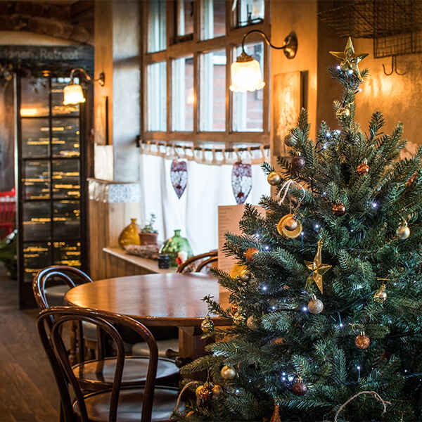 Small restaurant with a Christmas Tree by an empty table